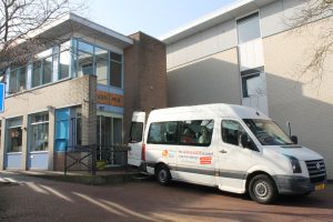 Rolstoelbus van Huis van Rie voor de ingang